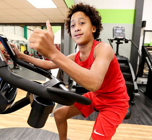 Picture of young man using gym equipment