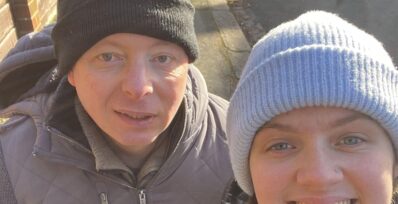 Image shows Simon with Lifestyle Coach, Rachael, both wearing coats and hats on a cold, sunny day.